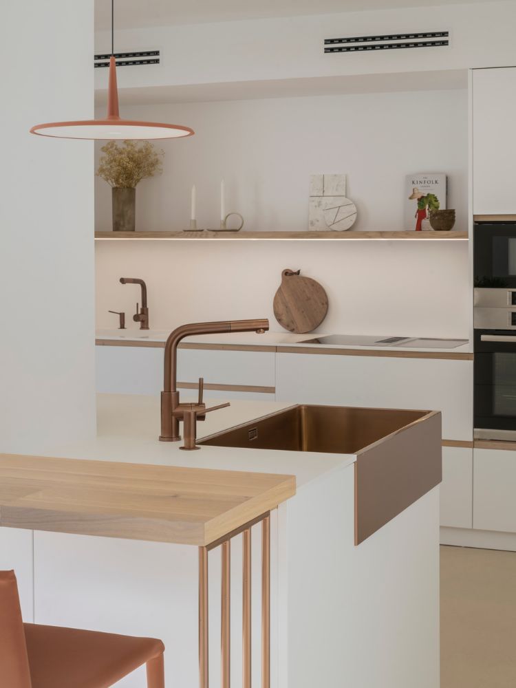 厨房面积与水水龙头,水槽,照明,与厨房软垫椅子和桌子都是copper-inspired。